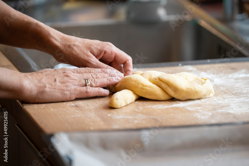 baking handmade easter braid with sweet yeast dough on countertop in kitchen © A2LE