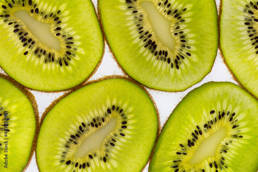 Close-up of transparent green kiwi slices as a background Close-up of transparent green kiwi slices as a background