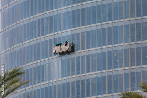 Professional glass cleaners working in a skyscraper
