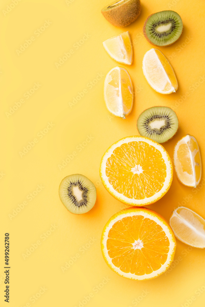 Fototapeta Sliced fruits top view. Healthy eating. Copy space