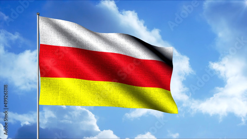 Waving flag of South Ossetia  seamless loop. Motion. Waving tricolor flag on flagpole on the background of blue sky and clouds.