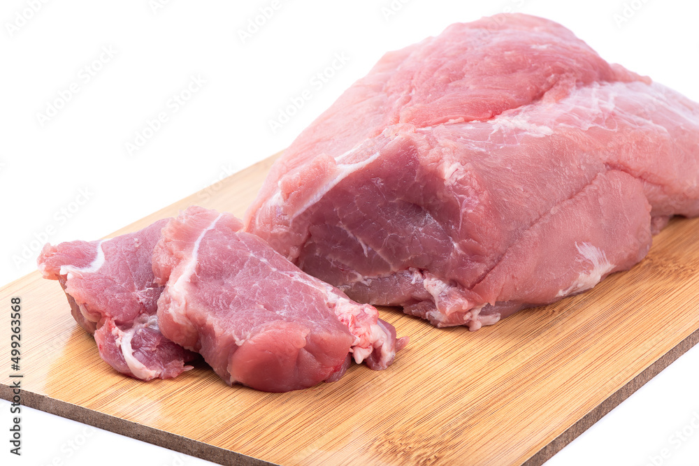 Sliced pieces of fresh juicy red meat for grilling on a cutting board.