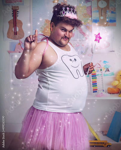 Forget the teeth, I want the candy. An overweight man dressed as the tooth fairy. photo