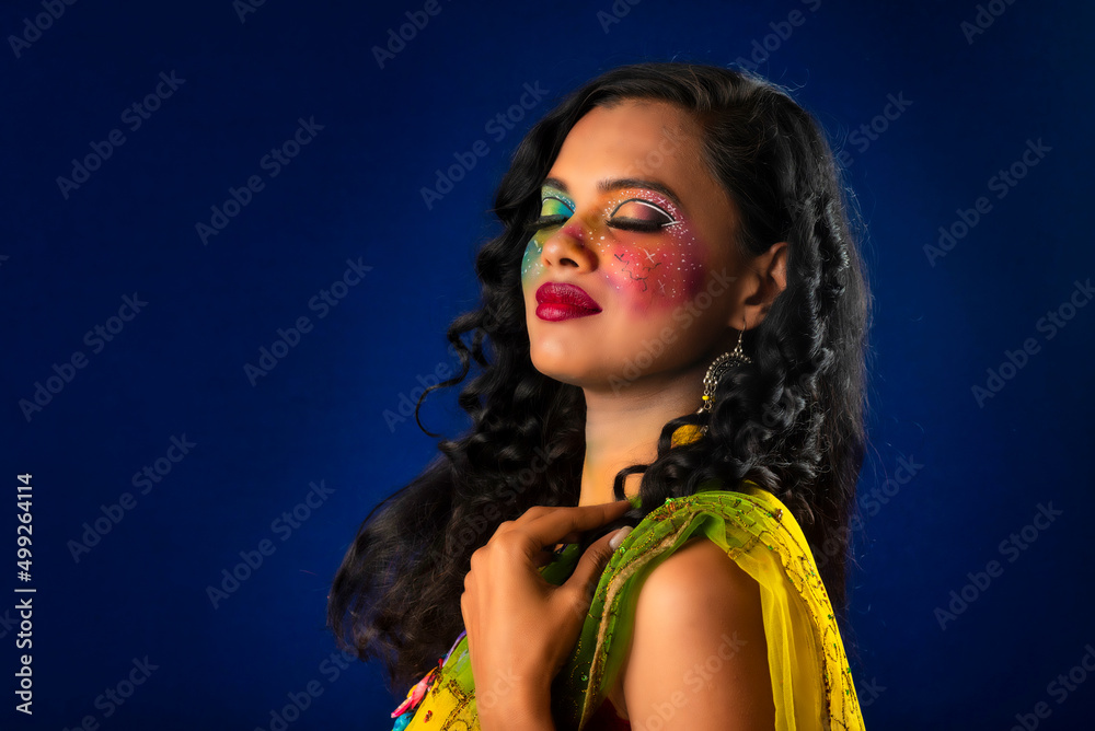 Fototapeta premium A gorgeous Young model beautiful woman or girl with perfect art creative makeup like a butterfly.