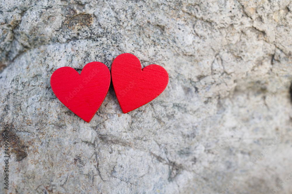 Two red hearts on stone surface . Copy space Two red hearts on stone surface . Copy space