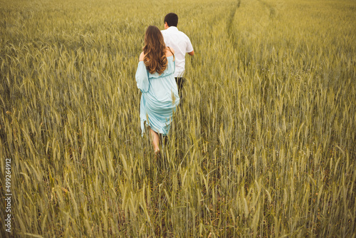 couple walking in a wheat field