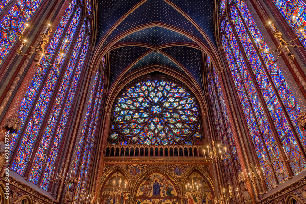 The rose window and the colorful stained glass side windows of the gothic Sainte-Chapelle in Paris, France