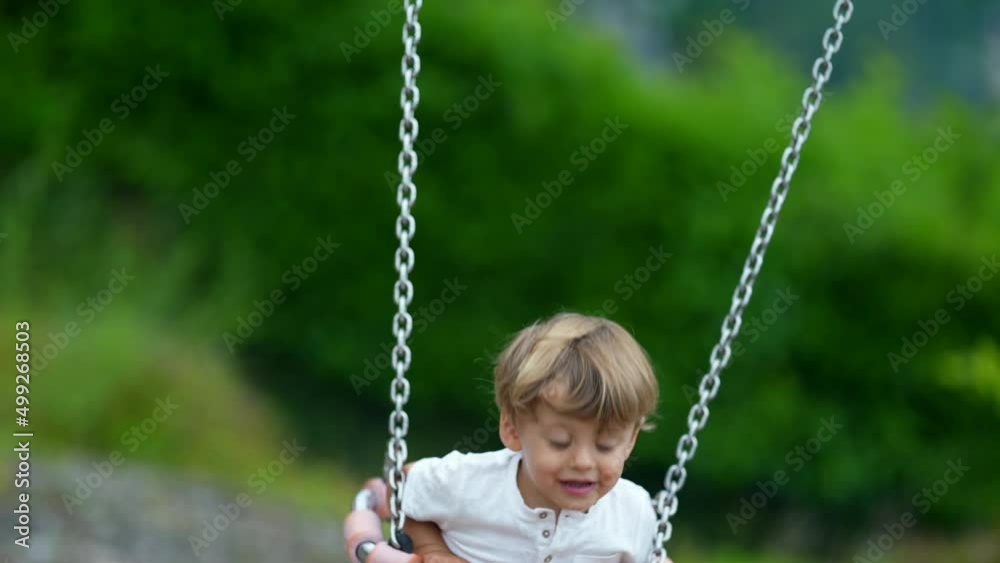 Little boy having fun at playground swing Little boy having fun at playground swing