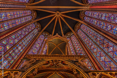 The altar and the huge stained glass windows of the gothic Sainte-Chapelle in Paris, France shot from below.