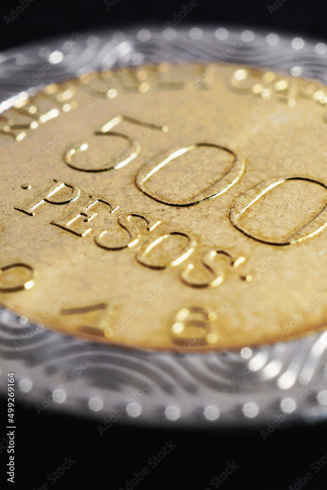 Translation: 500 Colombian pesos Republic of Colombia. Colombian coin 500 pesos. Peso of Colombia. News about economy or banking. Loan and credit. Wages and taxes. Vertical illustration. Macro Translation: 500 Colombian pesos Republic of Colombia. Colombian coin 500 pesos. Peso of Colombia. News about economy or banking. Loan and credit. Wages and taxes. Vertical illustration. Macro