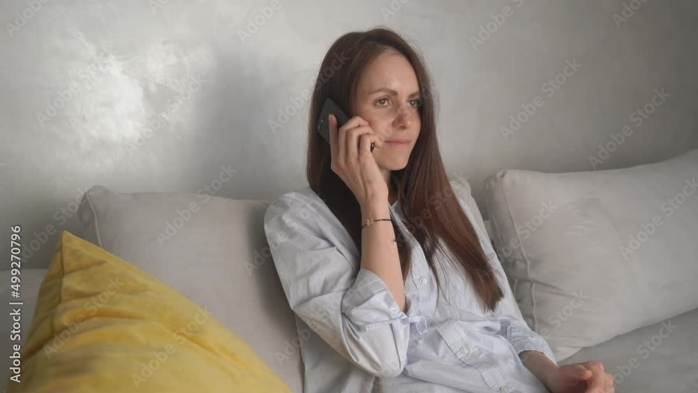 Focused business woman speaking mobile phone at home office. Closeup smiling lady talking smartphone. Portrait of beautiful girl flirting on phone at home. Focused business woman speaking mobile phone at home office. Closeup smiling lady talking smartphone. Portrait of beautiful girl flirting on phone at home.