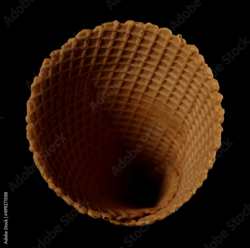 Empty ice cream cone isolated on black, top view  photo