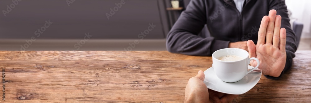 Man Refusing Cup Of Coffee Offered By Person