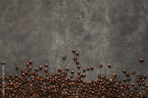 Fototapeta Roasted coffee beans on grey stone abstract background