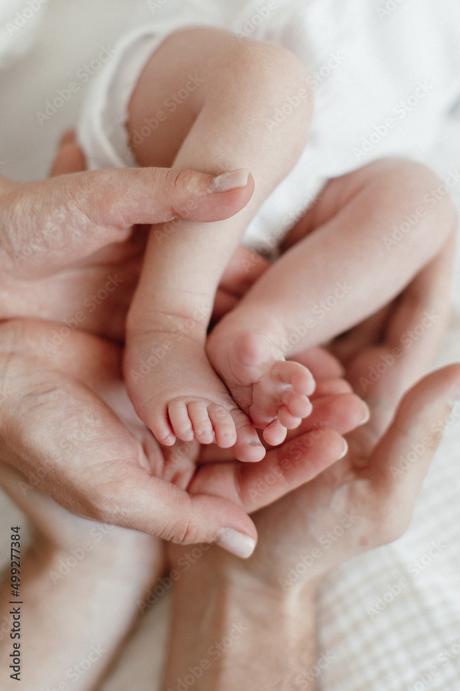 Newborn. Baby feet in mothers hands. Close up. Happy Family concept. Newborn. Baby feet in mothers hands. Close up. Happy Family concept.