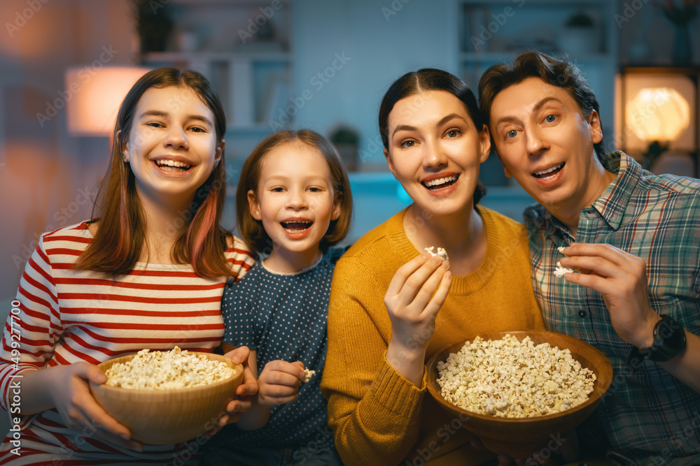 Obraz premium Mother, father and daughters spending time together.