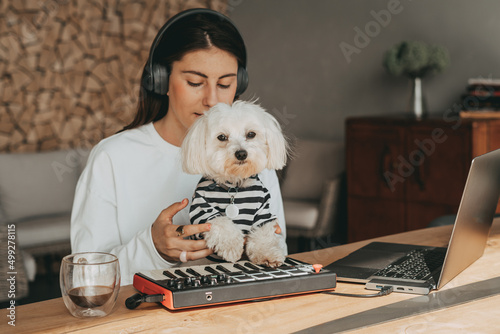 Music creation on midi keyboard with dog maltese
