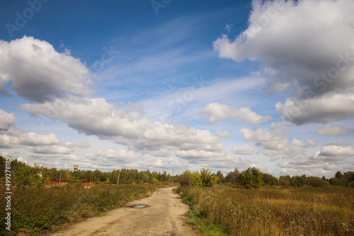 Rural landscape with ground road and filed in a countryside