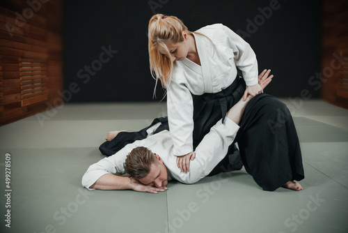 A man and a woman practice aikido indoor photo