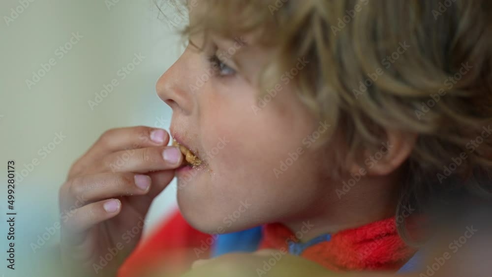 One pensive little boy eating cookie