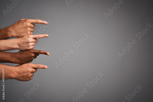 Thats the way. Studio shot of unidentifiable hands pointing sideways towards blank copyspace. photo