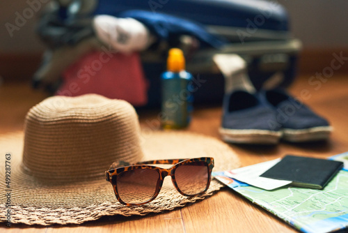Lets head out on an adventure. Cropped shot of travelling essentials on a table.