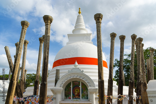 Thuparamaya stupa with remains of stone collumns, Sri Lanka (Translation of sign: Worshiping Buddha) photo