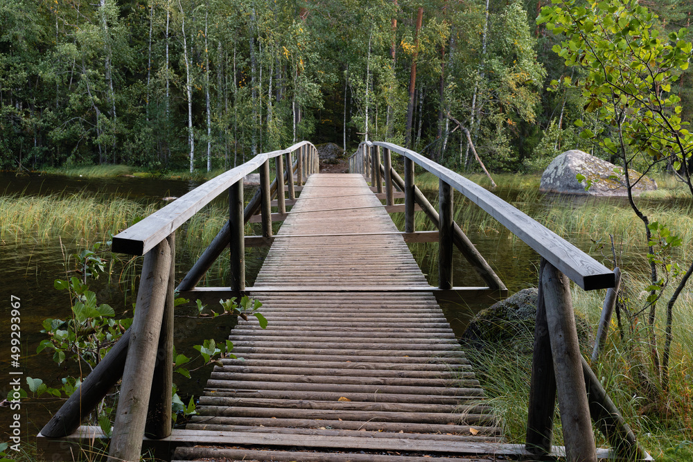 Obraz premium Wooden bridge over the river in Finland