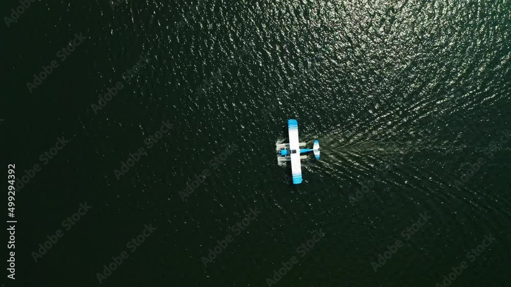 Aerial top down, seaplane floating on ocean lake water