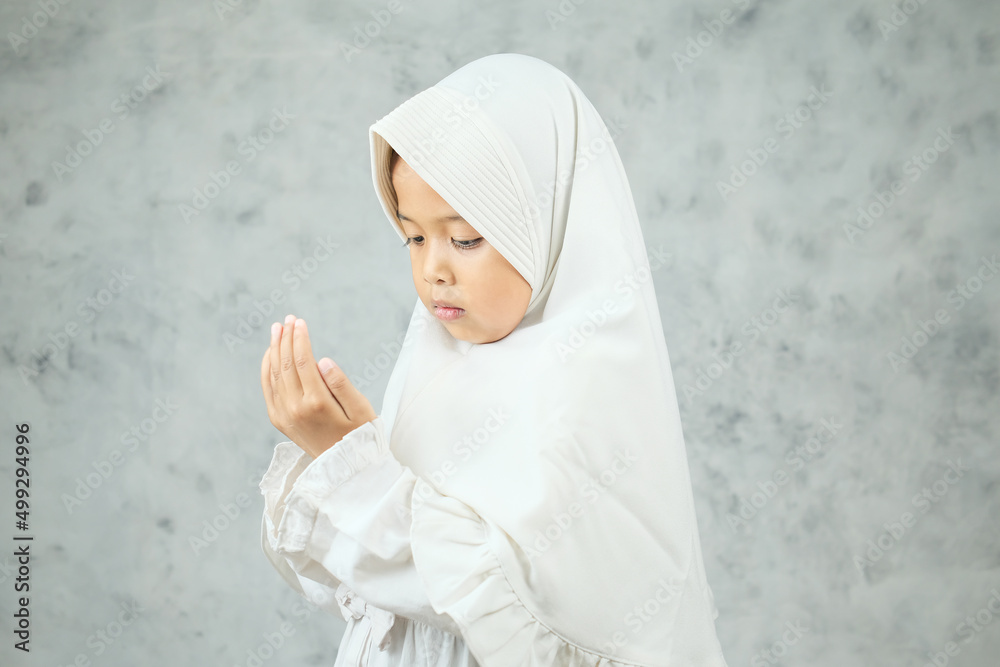 A little Asian Muslim girl is praying A little Asian Muslim girl is praying