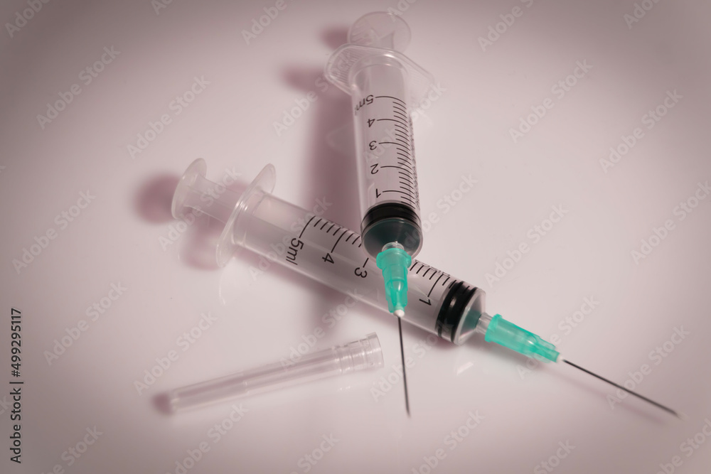 Medical syringe on a white background. A syringe for injection. The concept of health and beauty Medical syringe on a white background. A syringe for injection. The concept of health and beauty