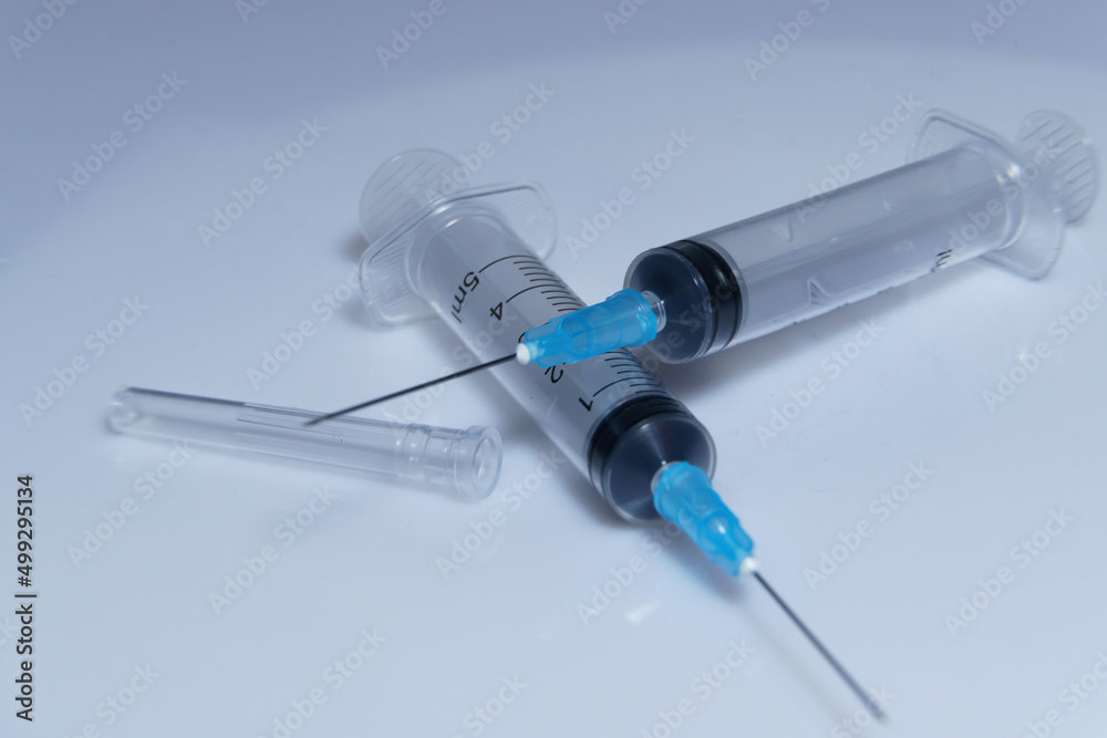 Medical syringe on a white background. A syringe for injection. The concept of health and beauty Medical syringe on a white background. A syringe for injection. The concept of health and beauty