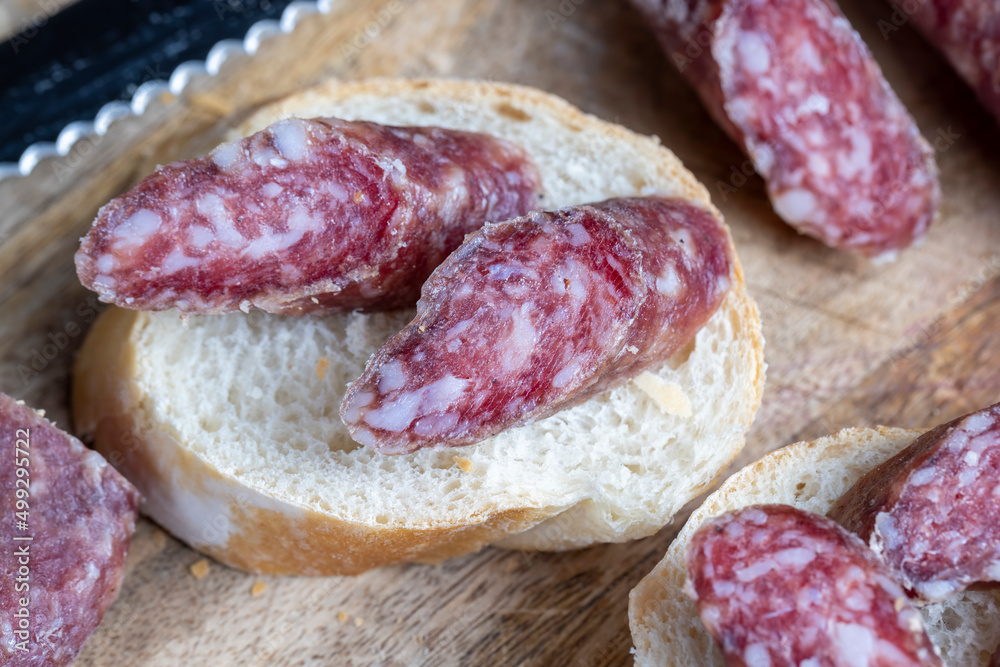 sliced pieces of sausage from meat are lying on a cutting board sliced pieces of sausage from meat are lying on a cutting board