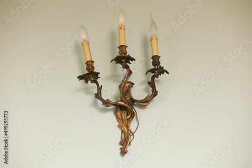 Фотография lamp in the form of a candlestick on the wall in the house