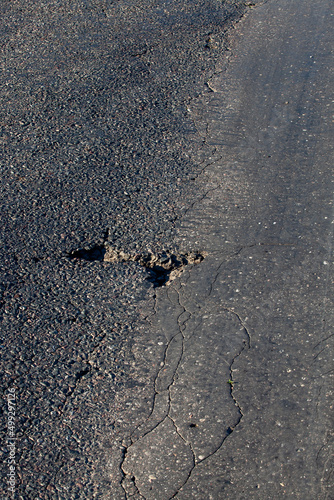 an asphalt road with holes