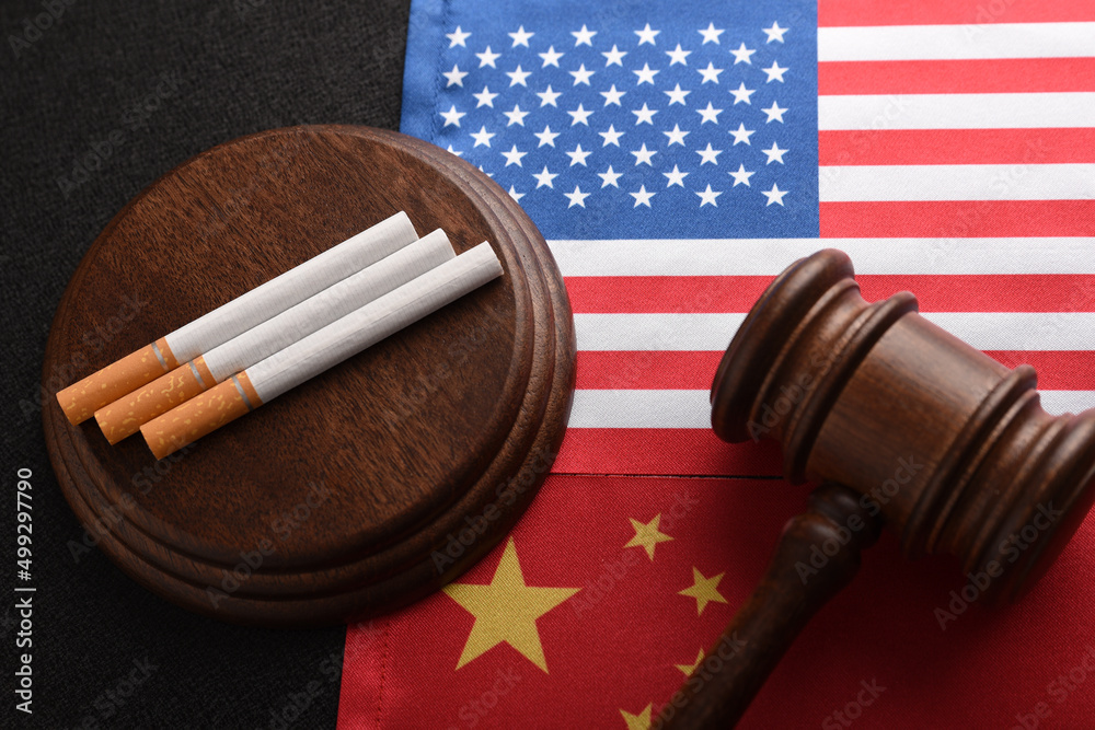 Cigarettes and Judge gavel on background of flag USA and China. Transportation of illegal tobacco goods. Smuggling.