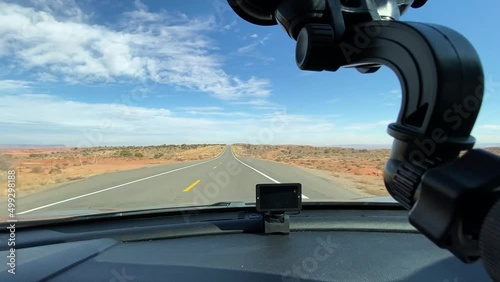 Driving on a straight road in the state of Utah and Arizona. The camera records through the windshield.