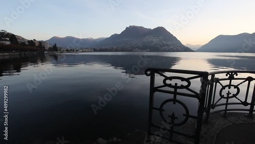 Sunrise on Lake Lugano with a view towards city and italian swiss border, Ticino, Switzerland