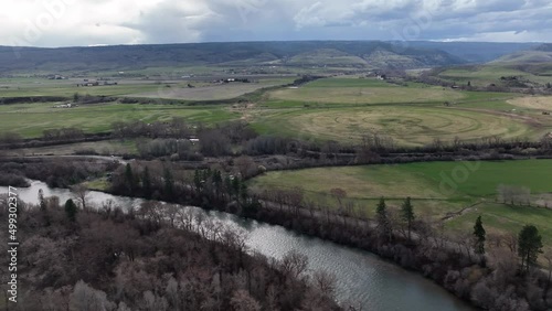 Cinematic 4K aerial drone flyover trucking shot of the Yakima River in Western Washington state near Ellensburg, Kittitas County near the foothills photo