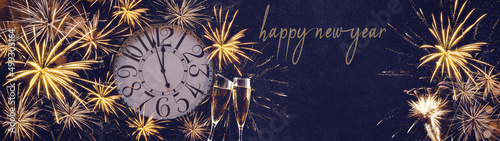 HAPPY NEW YEAR 2023 - Festive silvester New Year's Eve Party background panorama banner long - Golden yellow fireworks, clock and champagne classes toasting in the blue night