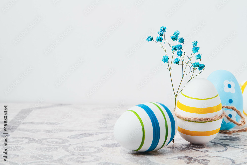 Fototapeta premium Easter. Multicolored eggs. Yellow and blue Easter decorations.