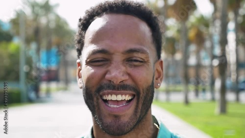 Young beautiful man with short hairs smiling at camera.