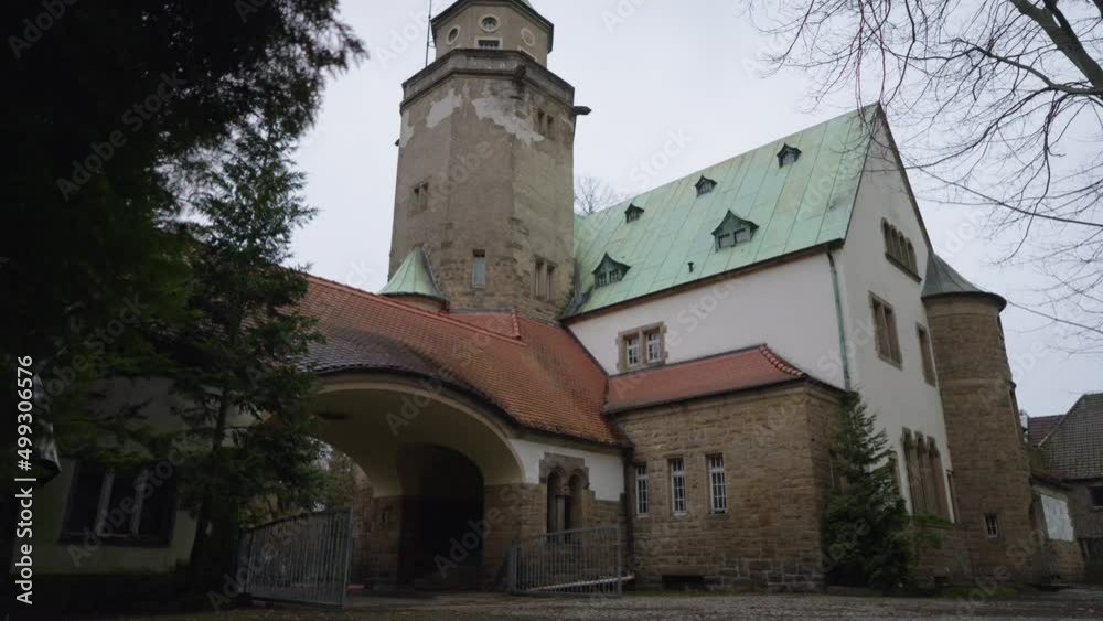Tilt shot revealing main gate and church tower with copper roof of an old castle in Germany Tilt shot revealing main gate and church tower with copper roof of an old castle in Germany