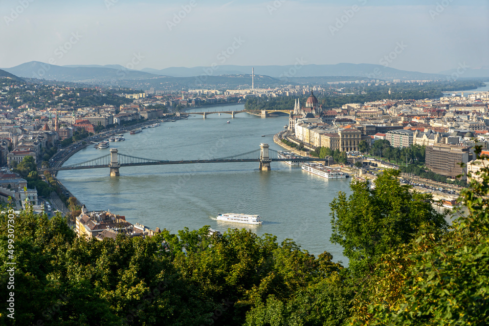 Fototapeta premium View of the Danube and Gellert Hill Szechenyi Chain Bridge and the Hungarian Parliament in Budapest. Selective focus on the city.