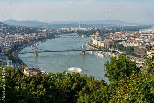 View of the Danube and Gellert Hill Szechenyi Chain Bridge and the Hungarian Parliament in Budapest. Selective focus on the city.