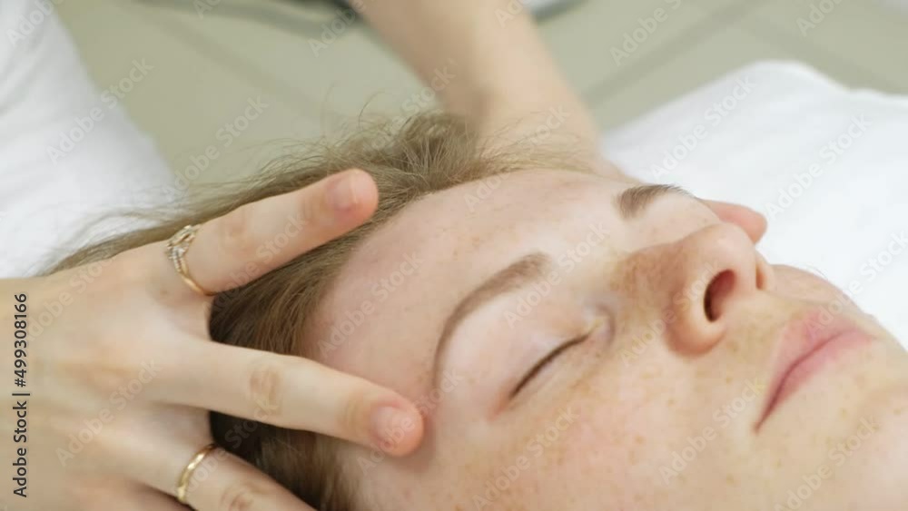 A masseur gives a woman a professional facial massage. The massage room performs a rejuvenation procedure. High quality Full HD footage A masseur gives a woman a professional facial massage. The massage room performs a rejuvenation procedure. High quality Full HD footage