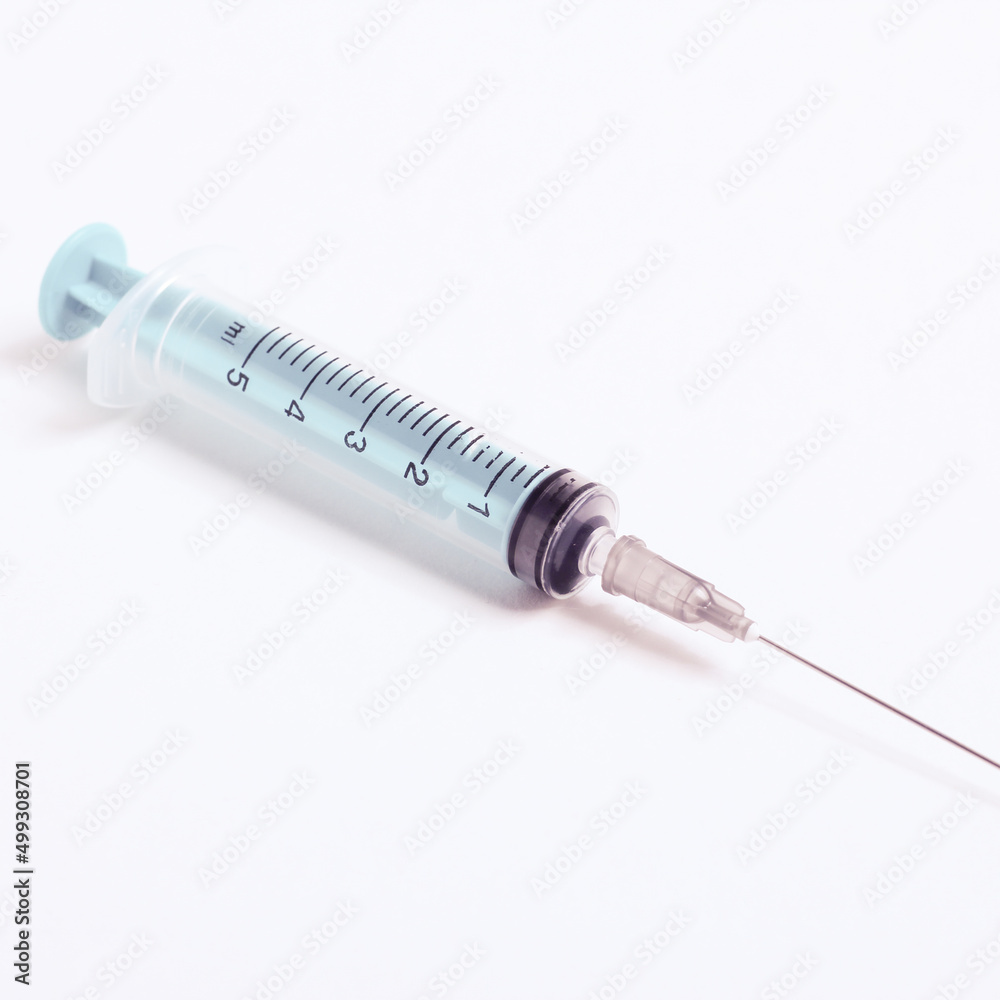 Medical syringe on a white background. A syringe for injection. The concept of health and beauty Medical syringe on a white background. A syringe for injection. The concept of health and beauty