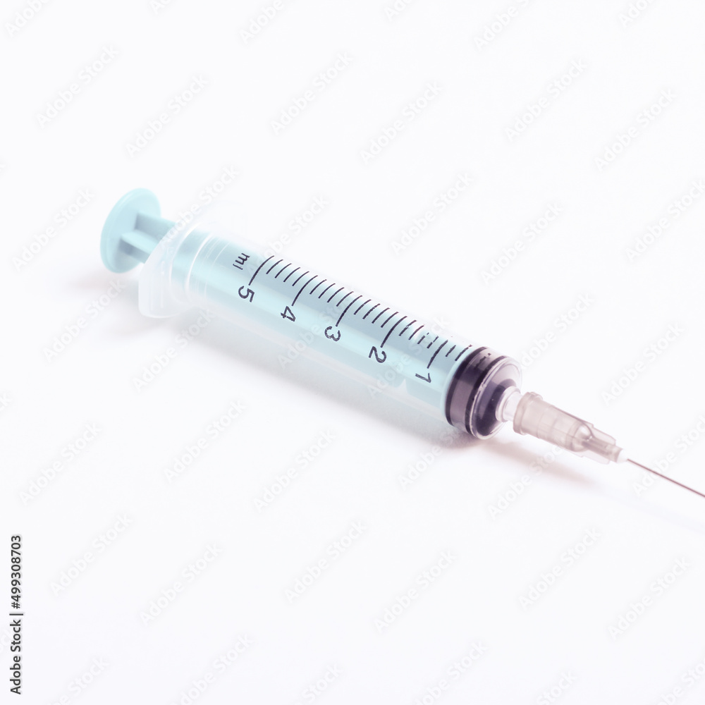 Medical syringe on a white background. A syringe for injection. The concept of health and beauty Medical syringe on a white background. A syringe for injection. The concept of health and beauty