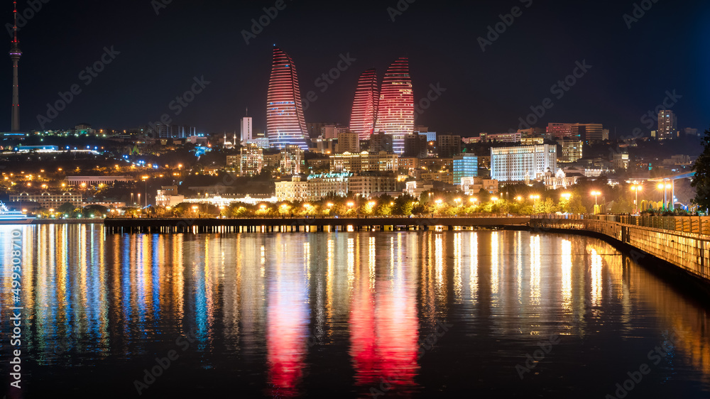 Baku, Azerbaijan - July 2019: Night view of Baku with the Flame Towers skyscrapers, television tower and the seaside of the Caspian sea
