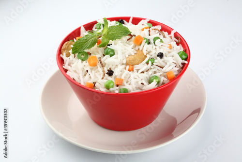 Red Bowl with rice and vegetable, green peas and carrots 